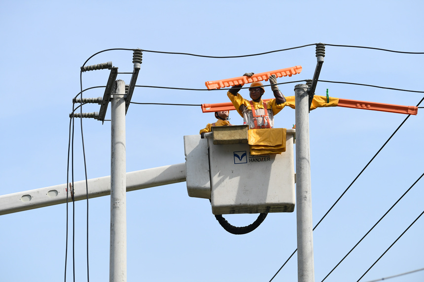 國網重慶市電力公司工作人員在巴南區界石鎮虎嘯村開展帶電作業。潘洪攝