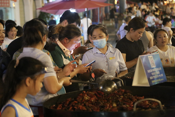游客品嘗海鮮燒烤。楊孝永攝