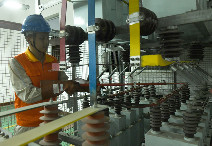 8月10日晚，國家電網紅巖（璧山運檢）共產黨員服務隊隊員在110千伏大路變電站檢修4號電容器。周毅攝