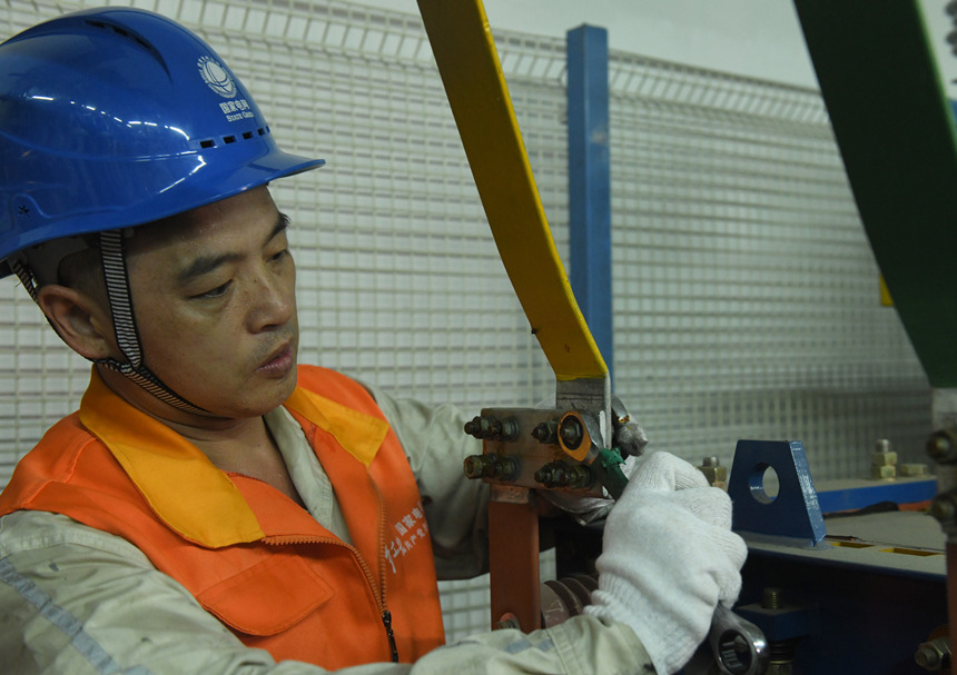 8月10日晚，國家電網紅巖（璧山運檢）共產黨員服務隊隊員在110千伏大路變電站檢修4號電容器。周毅攝