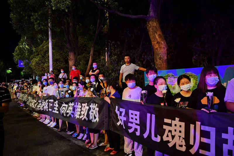 當地群眾自發迎接英雄回家。賀奎攝