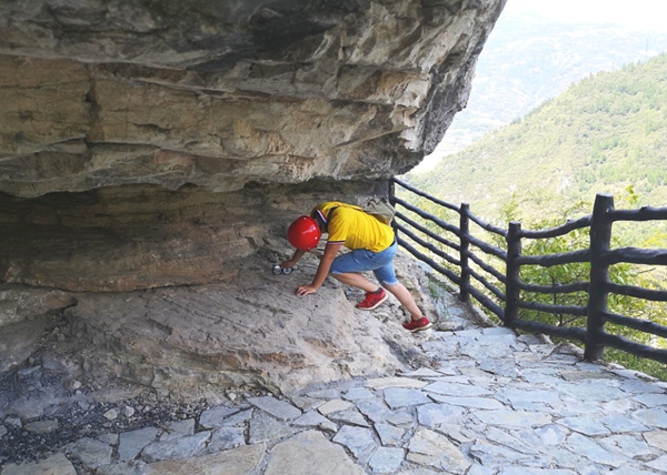 《吊嘴危巖現場調查》。8月上旬，為做好危巖風險管控，重慶地研院地災防治技術人員冒著高溫對奉節縣瞿塘峽吊嘴危巖用羅盤等儀器進行地層巖性、地質構造等基礎調查。王琦攝