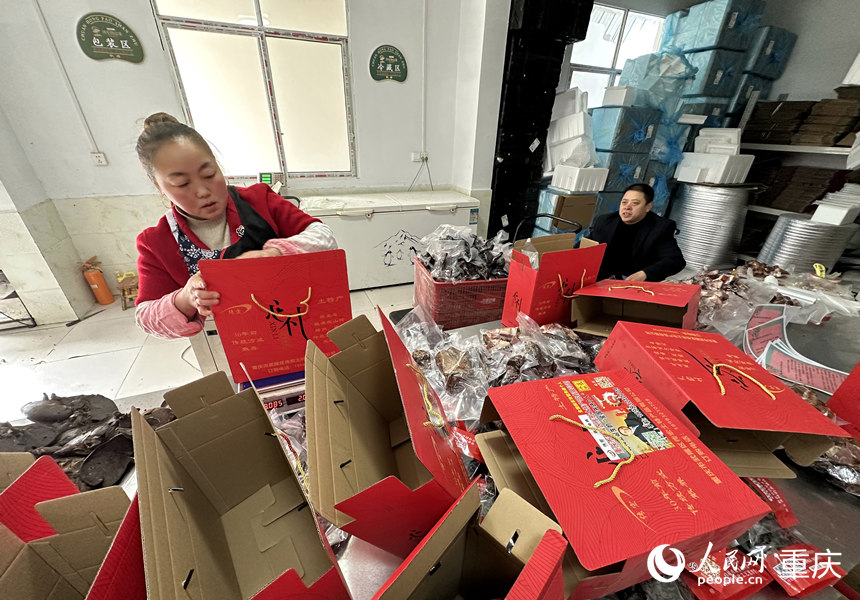 張永紅坐著輪椅在打包車間提醒注意事項。人民網 劉政寧攝