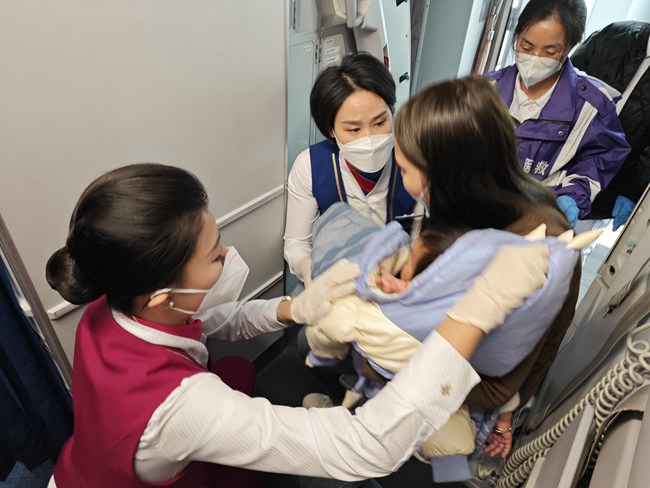 空乘人員對患病女童進行救護。重慶航空供圖