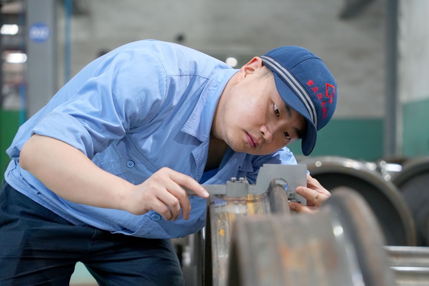 車輛鉗工正在進行輪對尺寸測量作業作業。吳晉超攝