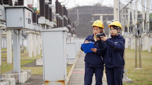 牛汝生在變電站開展設備測溫工作（左一）。國網重慶永川供電公司供圖