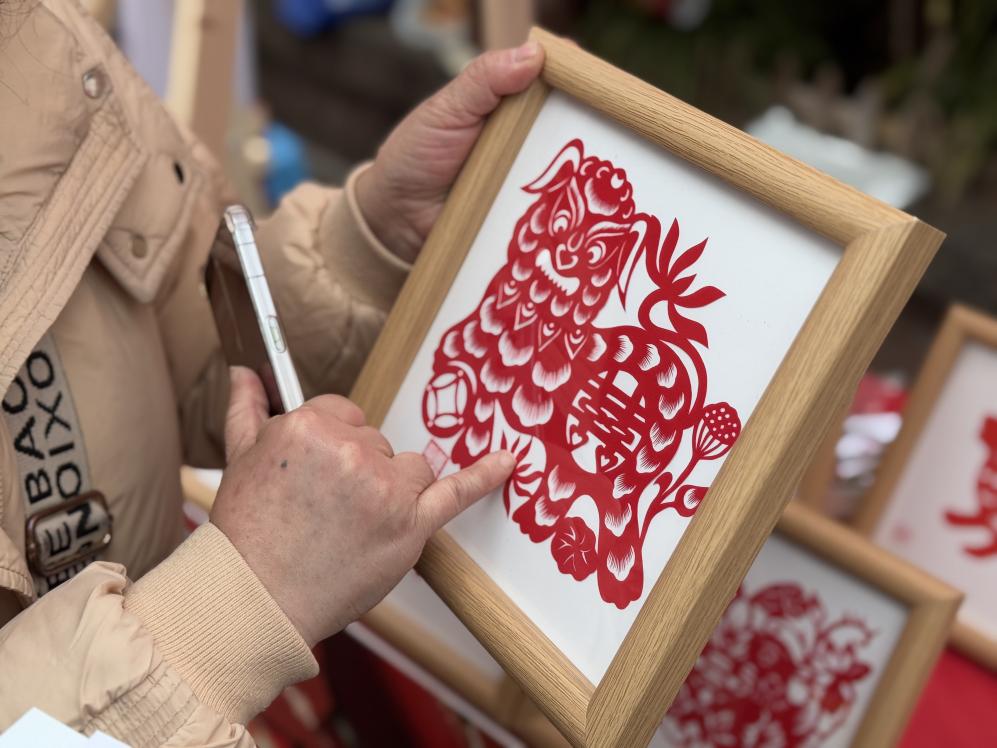 袁誼介紹自己的剪紙作品。黃亞輝攝