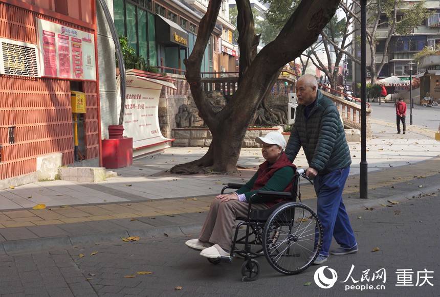 涂安全推著徐紅在社區散步。人民網記者 劉祎攝