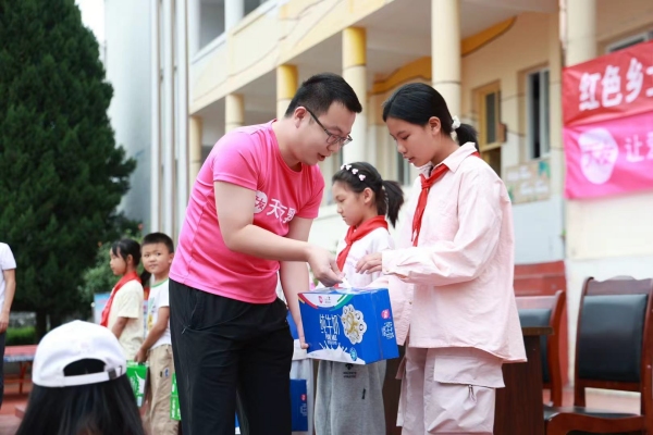 工作人員給學生捐贈牛奶。天友乳業供圖