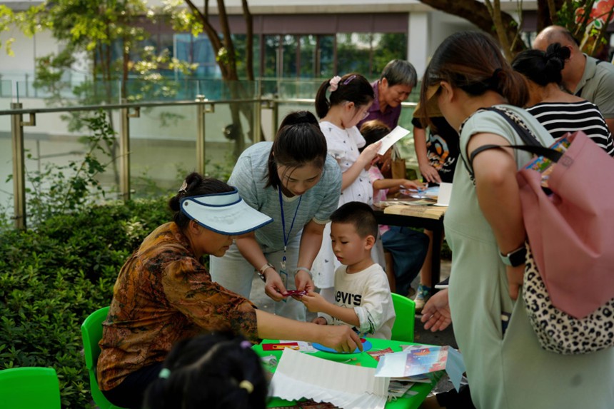 家長與孩子共同制作折扇和愛國主題貼畫。受訪者供圖